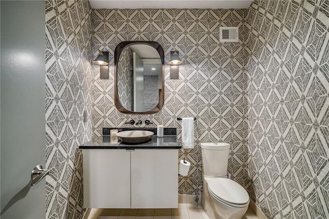 8700 Lee Blvd, Leawood, KS 66206 - bathroom featuring vanity, tile patterned floors, toilet, and tile walls