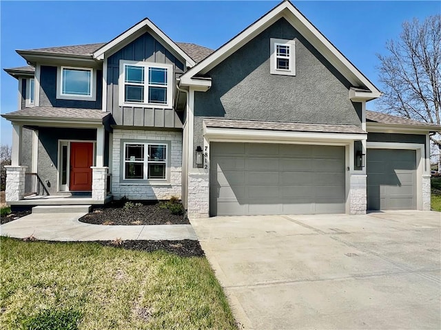 7812 N Spruce Ave, Kansas City, MO 64119 - craftsman-style home with board and batten siding, a garage, driveway, stone siding, and roof with shingles