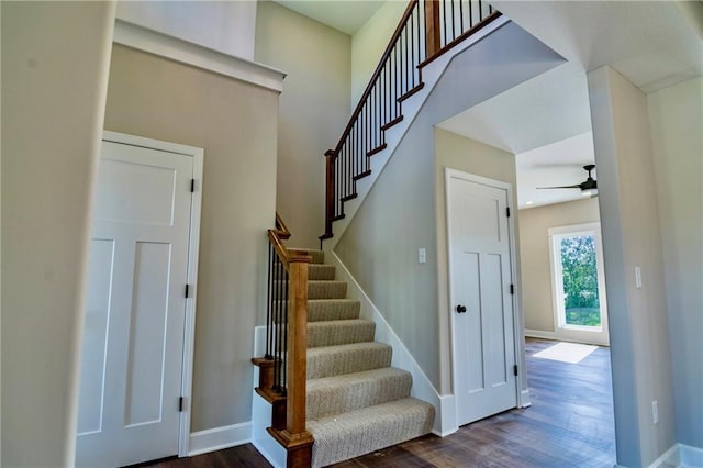 7812 N Spruce Ave, Kansas City, MO 64119 - stairs featuring wood finished floors, a ceiling fan, and baseboards