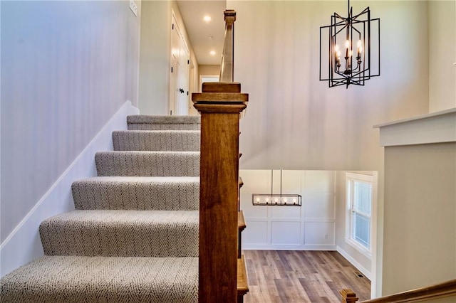 7812 N Spruce Ave, Kansas City, MO 64119 - stairs featuring a chandelier and wood finished floors