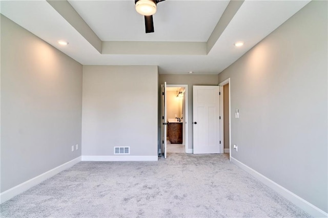 7812 N Spruce Ave, Kansas City, MO 64119 - unfurnished bedroom with carpet, recessed lighting, baseboards, connected bathroom, and a tray ceiling