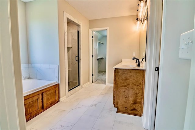 7812 N Spruce Ave, Kansas City, MO 64119 - full bath with a stall shower, marble finish floors, a garden tub, a walk in closet, and vanity