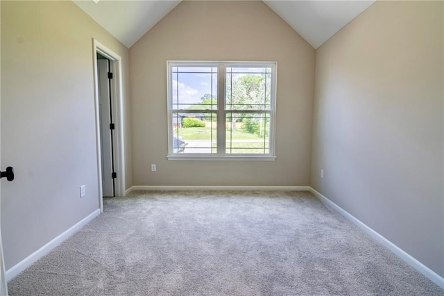 7812 N Spruce Ave, Kansas City, MO 64119 - empty room featuring healthy amount of natural light, carpet floors, lofted ceiling, and baseboards