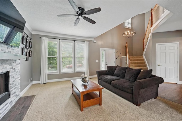 12287 S Mullen Rd, Olathe, KS 66062 - living area with stairs, plenty of natural light, a ceiling fan, a textured ceiling, and a fireplace