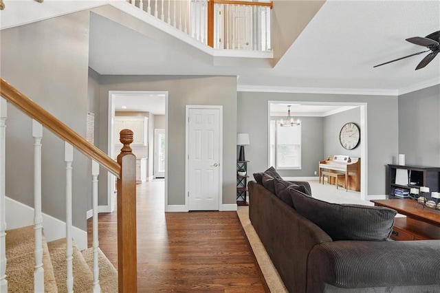 12287 S Mullen Rd, Olathe, KS 66062 - living room featuring a ceiling fan, stairway, wood finished floors, ornamental molding, and baseboards