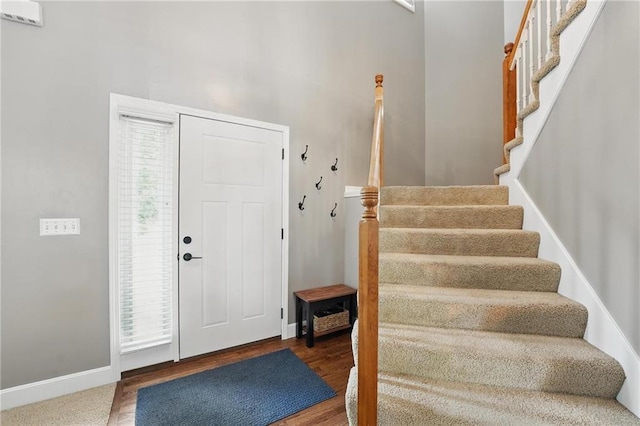 12287 S Mullen Rd, Olathe, KS 66062 - entryway featuring stairway, baseboards, and wood finished floors