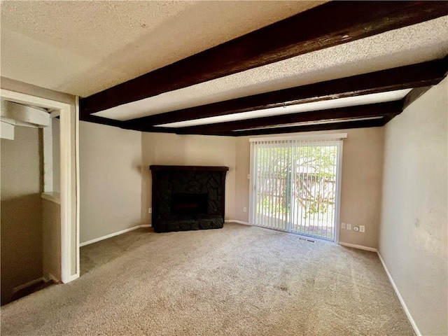 11914 E 59th Ter, Kansas City, MO 64133 - unfurnished living room with beamed ceiling, carpet flooring, a premium fireplace, a textured ceiling, and baseboards
