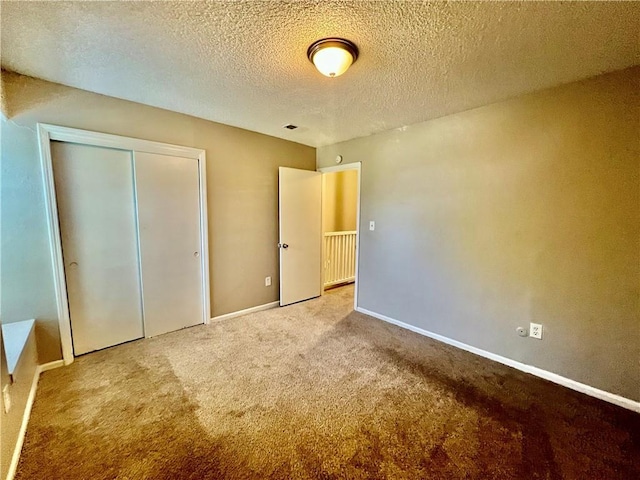 11914 E 59th Ter, Kansas City, MO 64133 - unfurnished bedroom featuring carpet, baseboards, a closet, and a textured ceiling