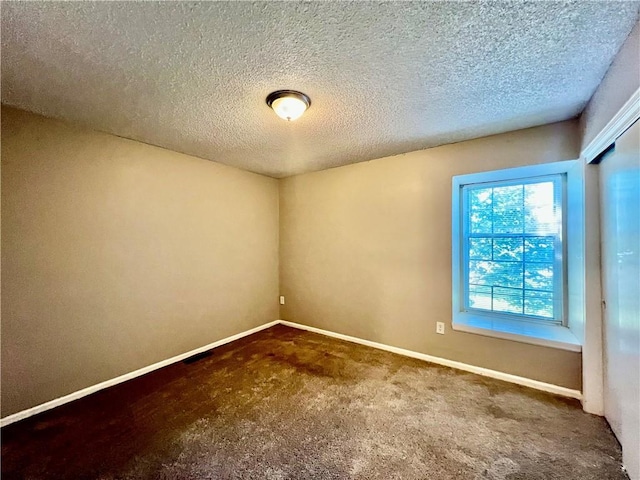 11914 E 59th Ter, Kansas City, MO 64133 - spare room with carpet floors, baseboards, and a textured ceiling