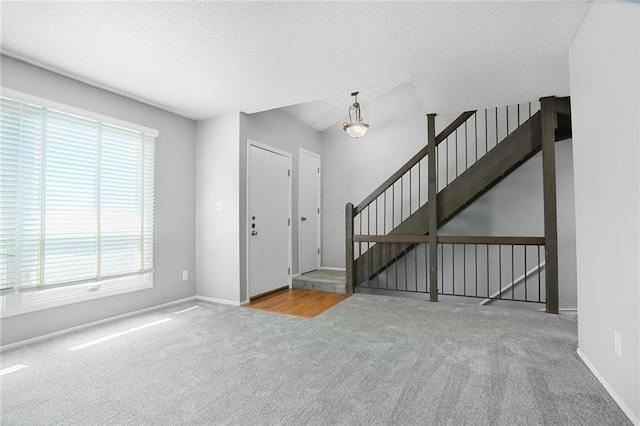 10981 Rosehill Rd, Overland Park, KS 66210 - foyer with carpet floors, plenty of natural light, a textured ceiling, and baseboards