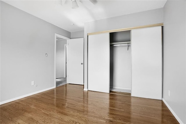 10981 Rosehill Rd, Overland Park, KS 66210 - unfurnished bedroom featuring wood finished floors, a closet, a ceiling fan, and baseboards
