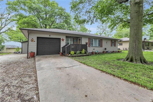 203 Pine St, Wellsville, KS 66092 - ranch-style home featuring concrete driveway, an attached garage, a front yard, and a porch