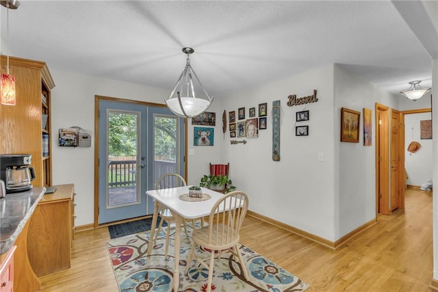 203 Pine St, Wellsville, KS 66092 - dining room featuring light wood-type flooring, baseboards, and a wood stove