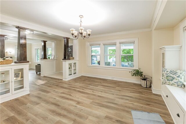 1515 E 77th Ter, Kansas City, MO 64131 - unfurnished dining area featuring ornamental molding, ornate columns, a chandelier, and light wood-type flooring