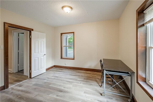 1515 E 77th Ter, Kansas City, MO 64131 - unfurnished office with wood finished floors and a textured ceiling