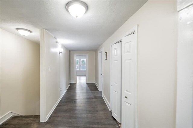 1515 E 77th Ter, Kansas City, MO 64131 - hall with dark wood-style flooring and a textured ceiling
