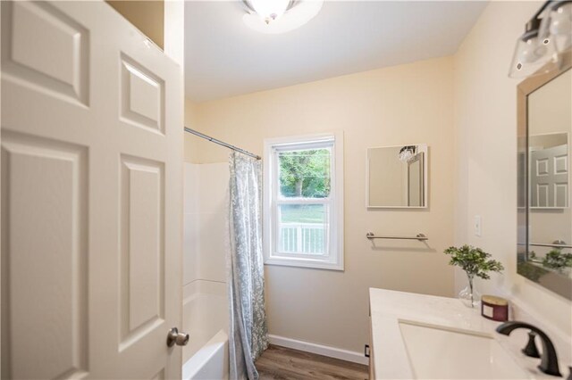 1515 E 77th Ter, Kansas City, MO 64131 - full bathroom with vanity, wood finished floors, and shower / bath combo