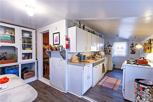 kitchen with white gas range, lofted ceiling, white cabinetry, dark wood-style flooring, and light countertops