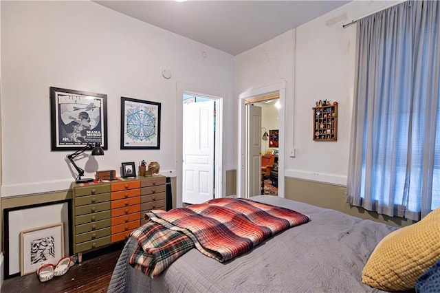 bedroom with dark wood-style floors