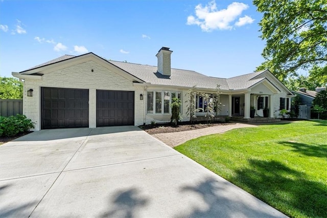 ranch-style house featuring an attached garage, driveway, a chimney, and a front yard