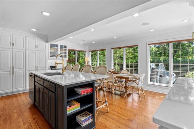 kitchen with a sink, crown molding, white cabinets, open shelves, and healthy amount of natural light