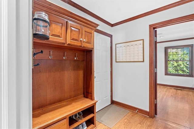 mudroom featuring light wood-style flooring, ornamental molding, and baseboards