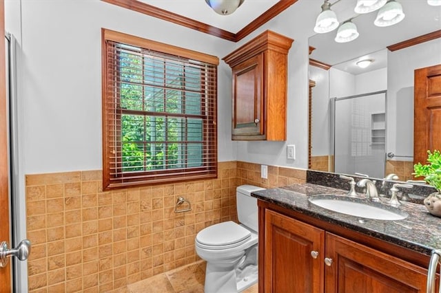 full bathroom featuring tile walls, ornamental molding, a shower stall, a wainscoted wall, and toilet