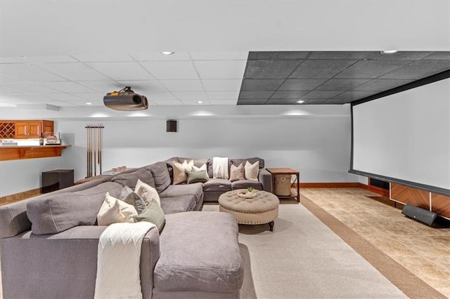 home theater with recessed lighting, a paneled ceiling, and baseboards