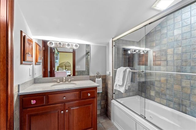 bathroom with vanity and enclosed tub / shower combo