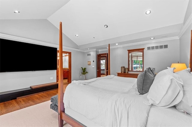 bedroom with lofted ceiling, recessed lighting, crown molding, and wood finished floors