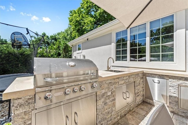 view of patio with a sink and area for grilling