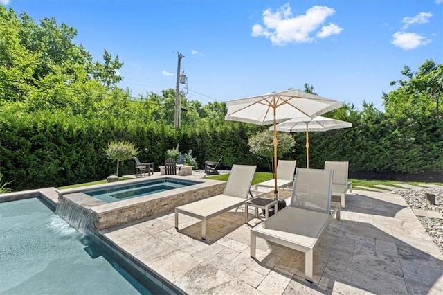 swimming pool featuring a patio area and an in-ground hot tub