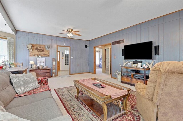 827 Pacific Ave, Osawatomie, KS 66064 - living area with a ceiling fan, wood walls, and carpet