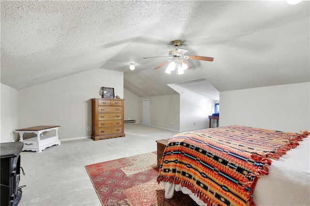 827 Pacific Ave, Osawatomie, KS 66064 - bedroom with carpet floors, vaulted ceiling, baseboards, ceiling fan, and a textured ceiling