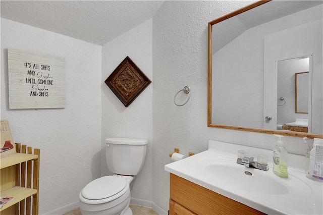 827 Pacific Ave, Osawatomie, KS 66064 - half bathroom featuring toilet, vanity, tile patterned flooring, and a textured wall