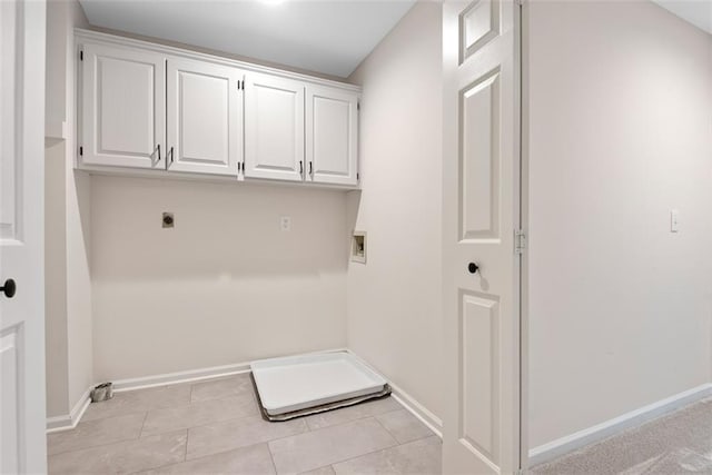 1051 E 121st St, Olathe, KS 66061 - washroom with hookup for an electric dryer, cabinet space, baseboards, light tile patterned floors, and hookup for a washing machine