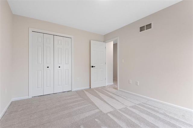 1051 E 121st St, Olathe, KS 66061 - unfurnished bedroom featuring baseboards, light carpet, and a closet