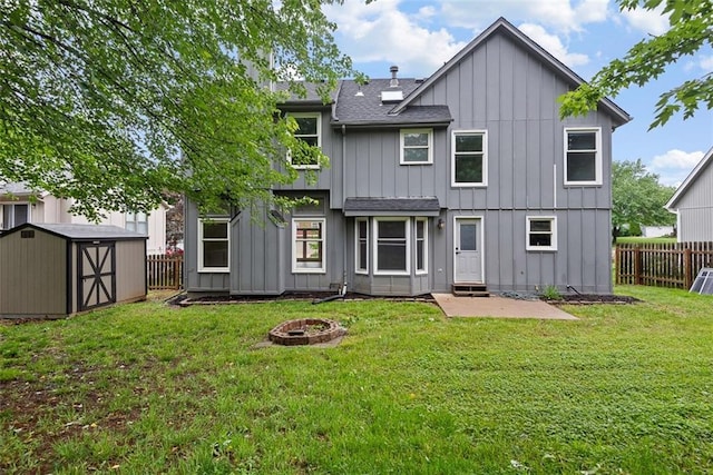 1051 E 121st St, Olathe, KS 66061 - back of property featuring board and batten siding, roof with shingles, an outdoor fire pit, and a patio