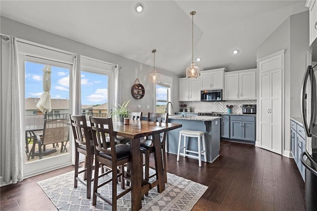 16025 Craig St, Basehor, KS 66007 - dining room featuring lofted ceiling, dark wood-style floors, and recessed lighting