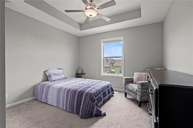 16025 Craig St, Basehor, KS 66007 - carpeted bedroom featuring a tray ceiling, baseboards, and a ceiling fan