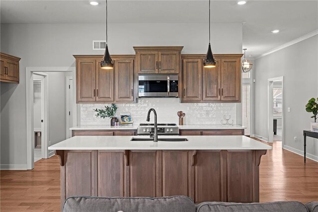 1532 SW Arbor Valley Dr, Lees Summit, MO 64082 - kitchen featuring stainless steel microwave, a sink, light countertops, decorative backsplash, and recessed lighting