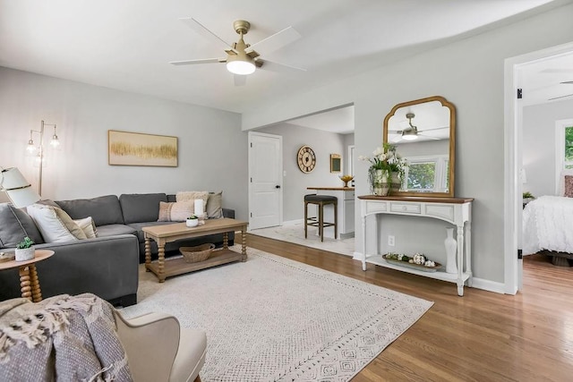 9811 Cambridge Ave, Kansas City, MO 64134 - living room with a ceiling fan, wood finished floors, and baseboards
