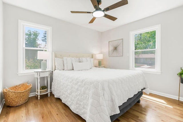 9811 Cambridge Ave, Kansas City, MO 64134 - bedroom with wood finished floors, baseboards, and a ceiling fan