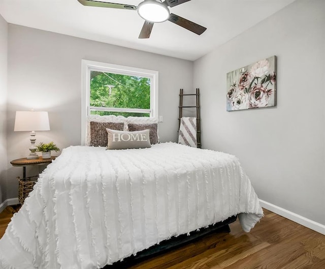 9811 Cambridge Ave, Kansas City, MO 64134 - bedroom featuring dark wood finished floors, baseboards, and a ceiling fan