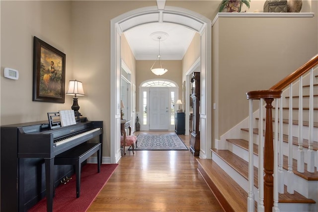 4704 SW Gull Point Dr, Lees Summit, MO 64082 - foyer entrance with wood finished floors, arched walkways, stairway, and baseboards