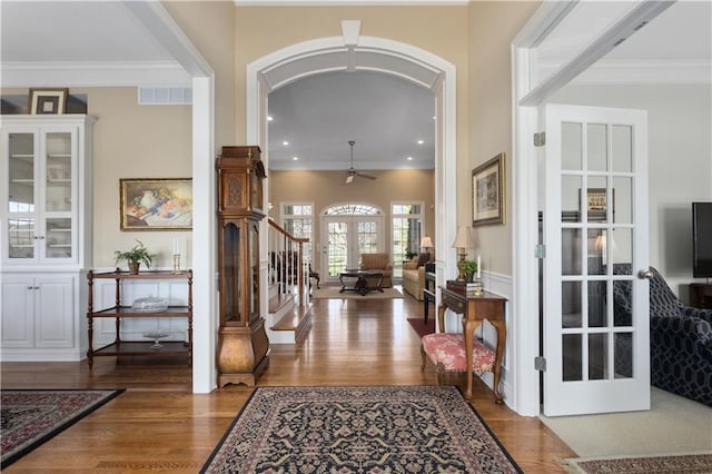 4704 SW Gull Point Dr, Lees Summit, MO 64082 - foyer entrance featuring arched walkways, wood finished floors, crown molding, stairway, and recessed lighting