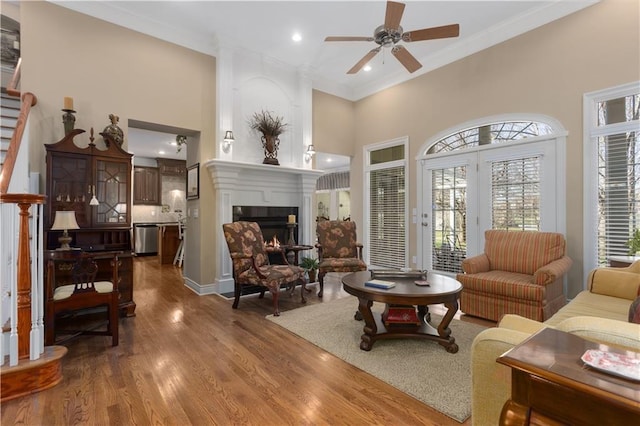4704 SW Gull Point Dr, Lees Summit, MO 64082 - living room with a ceiling fan, ornamental molding, a warm lit fireplace, recessed lighting, and dark wood finished floors