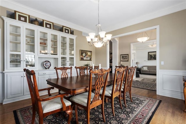 4704 SW Gull Point Dr, Lees Summit, MO 64082 - dining space with a chandelier, dark wood finished floors, wainscoting, and ornamental molding