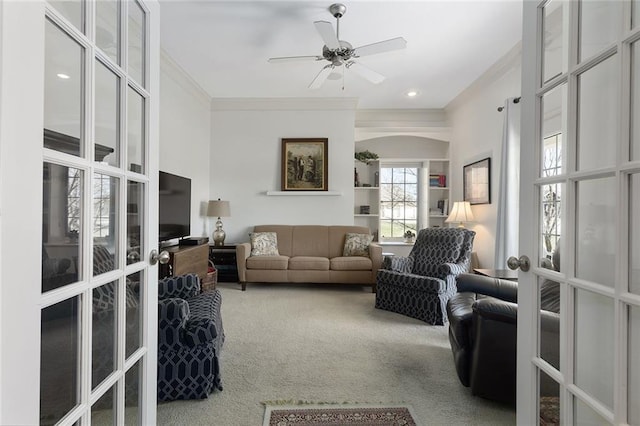 4704 SW Gull Point Dr, Lees Summit, MO 64082 - living area with french doors, crown molding, carpet, arched walkways, and ceiling fan