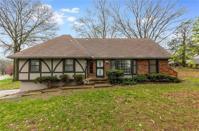 6701 E 127th St, Grandview, MO 64030 - view of front of property with a front yard, stucco siding, roof with shingles, and brick siding